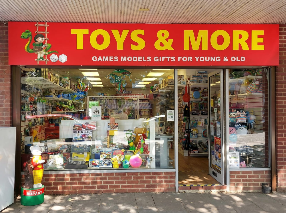 Toy store with a red sign reading 'Toys & More' on a brick building.
